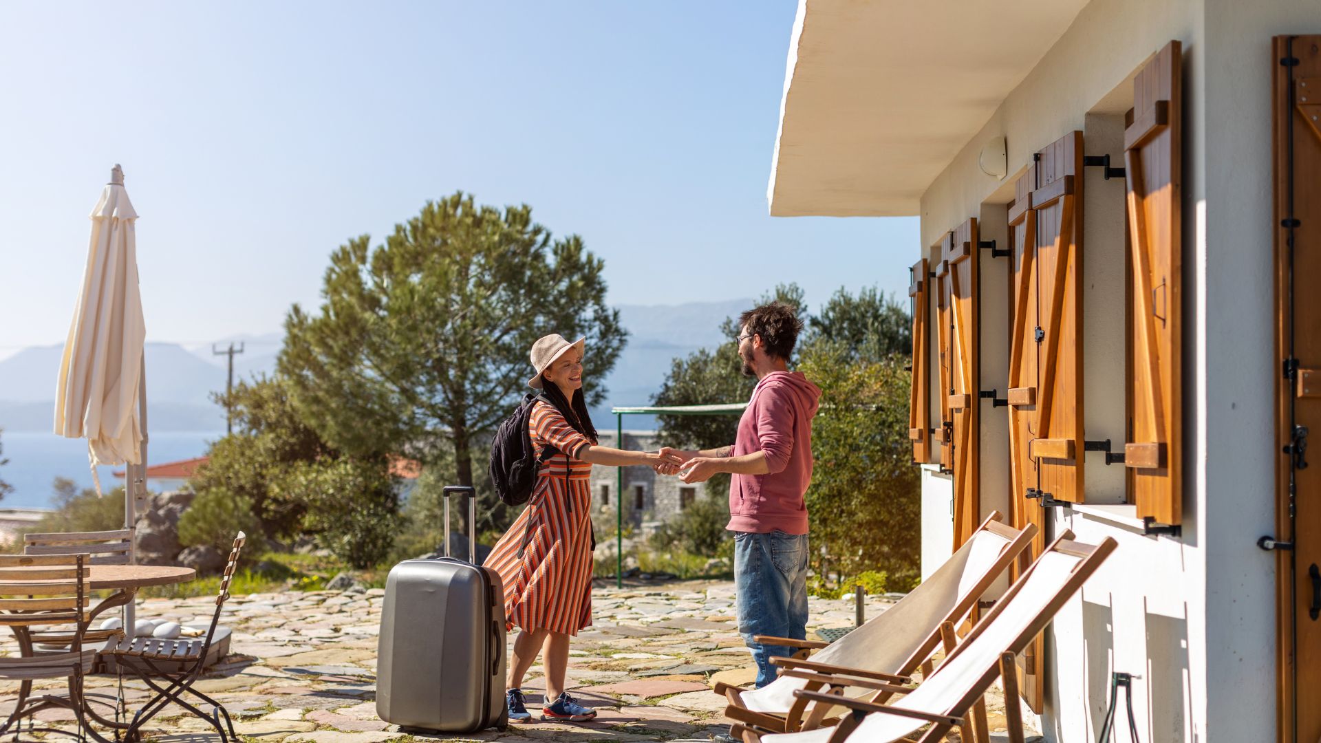 Guest being welcomed outside property